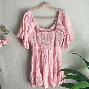 Woman’s pink smocked linen mini dress